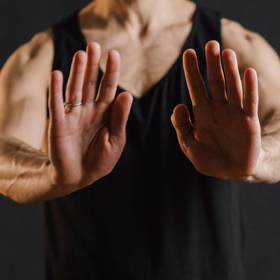 Close-up of hands in a meditative mudra gesture.